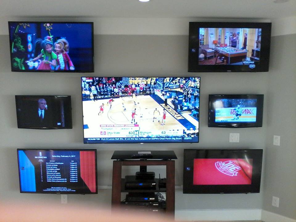 Many TVs on wall